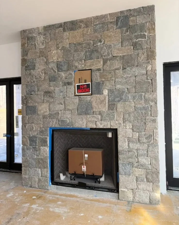Natural stone veneer fireplace installed in a Connecticut home