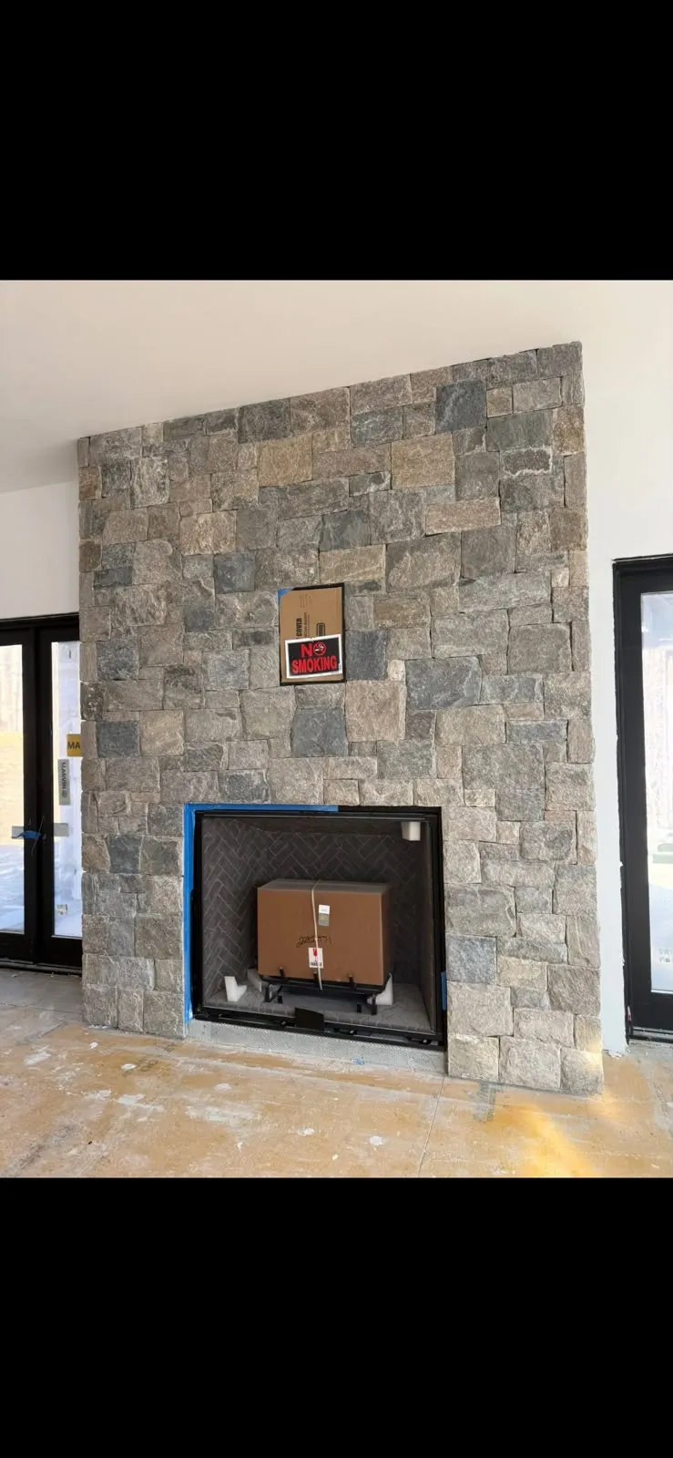 Natural stone veneer fireplace installed in a Connecticut home