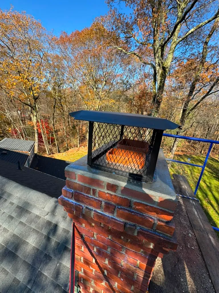 Finished brick chimney with a new metal cap in Connecticut