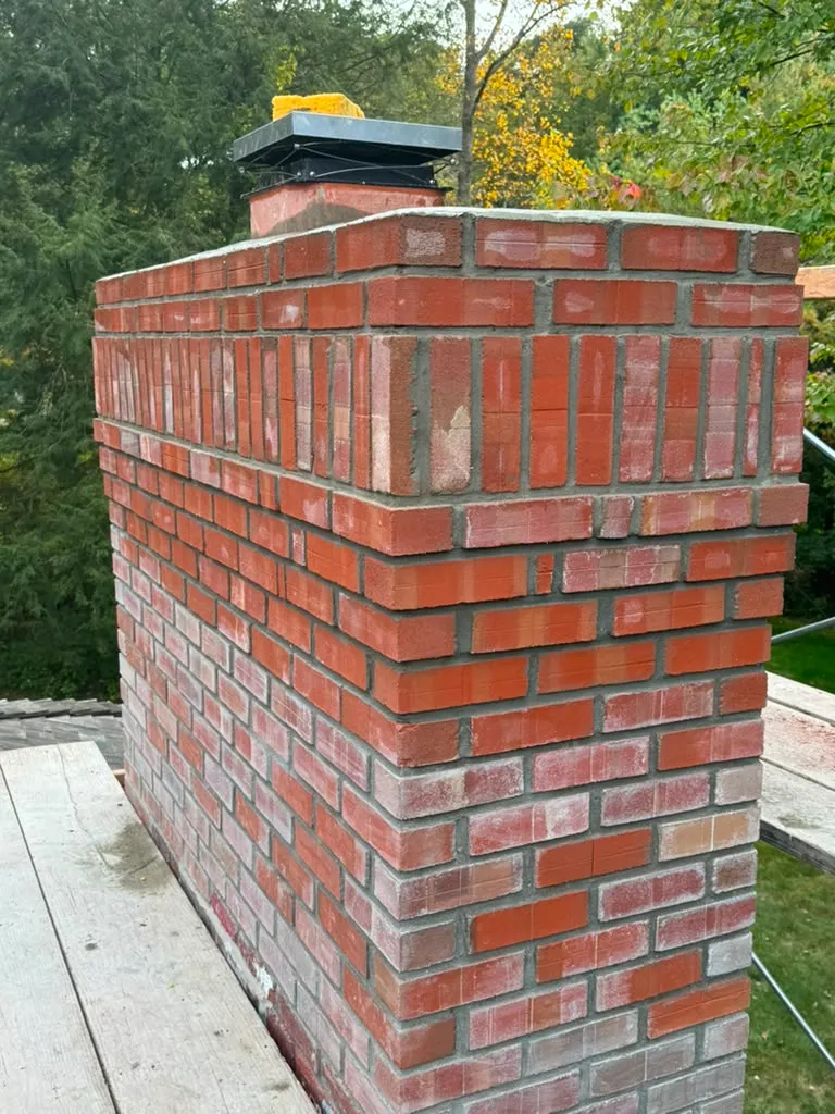 New brickwork with corbeled detail on a chimney in Connecticut
