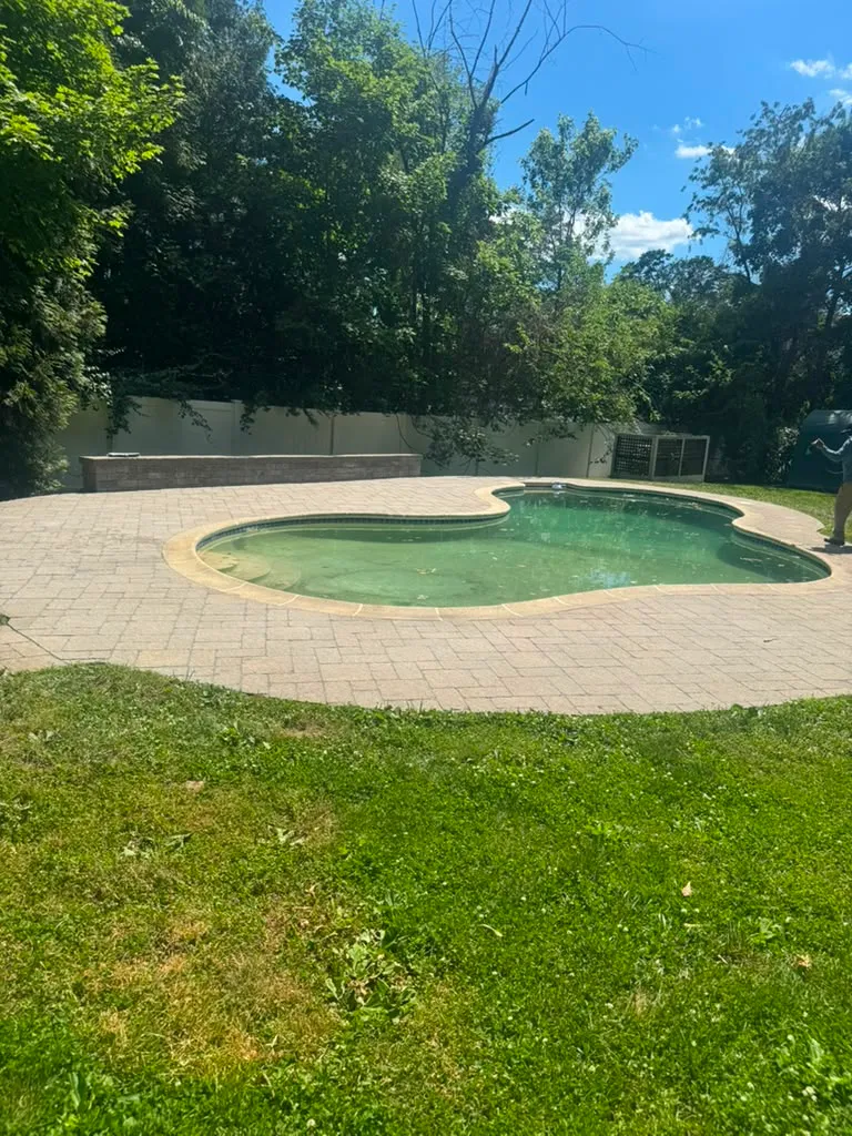 Finished backyard with paver pool deck and new lawn in Connecticut